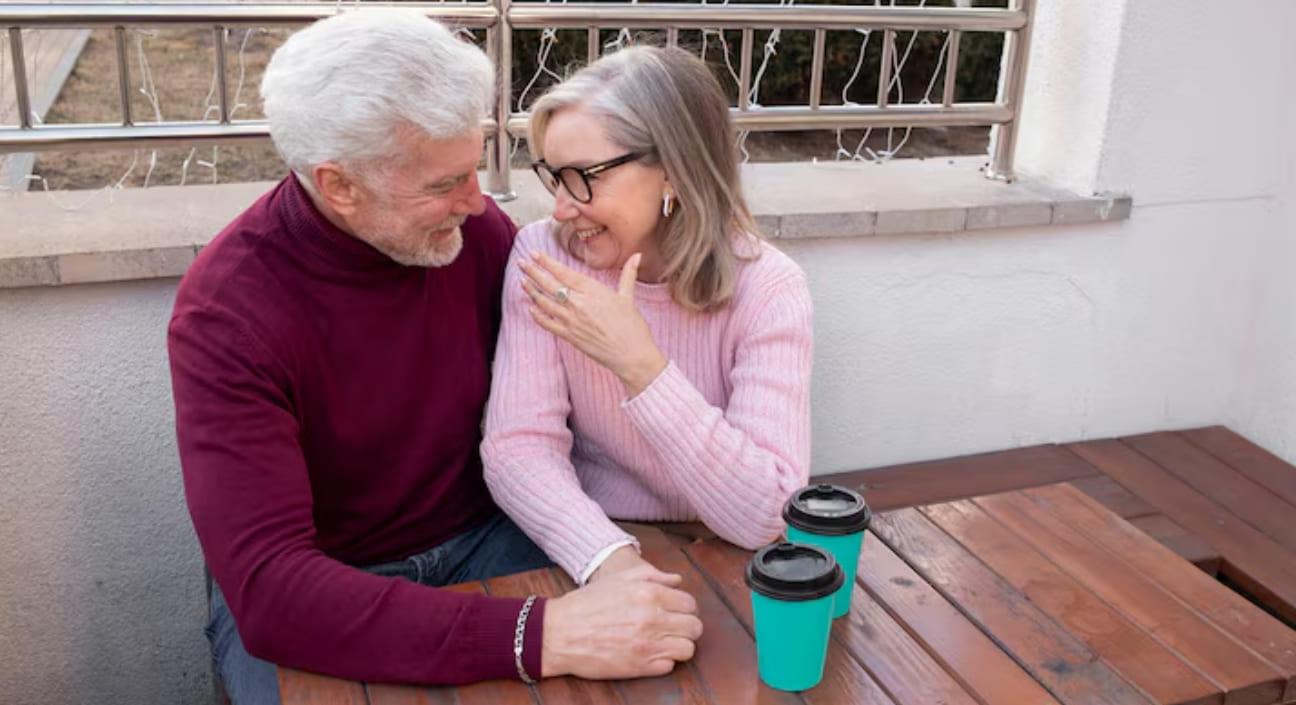 Two retired singles laughing together outdoors