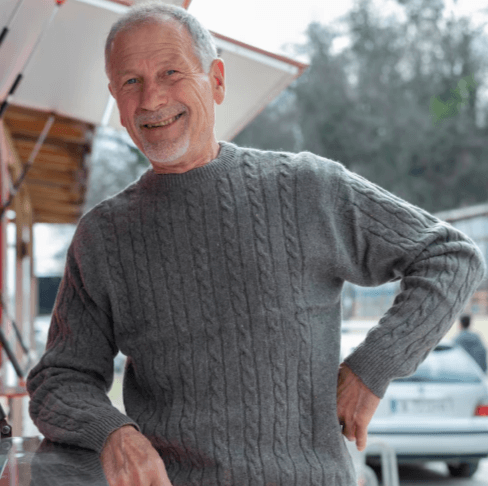 Senior man taking a well-lit selfie outdoors